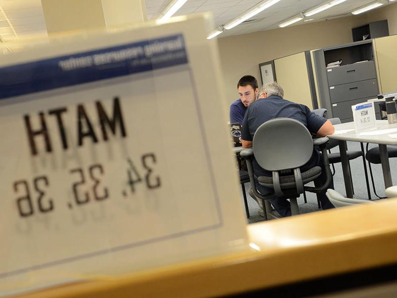 A student working with a tutor at the Learning Resources Center